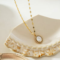 HAMMELA Gold: Pendant Necklace with a Pearl Centre & Crystal Halo
